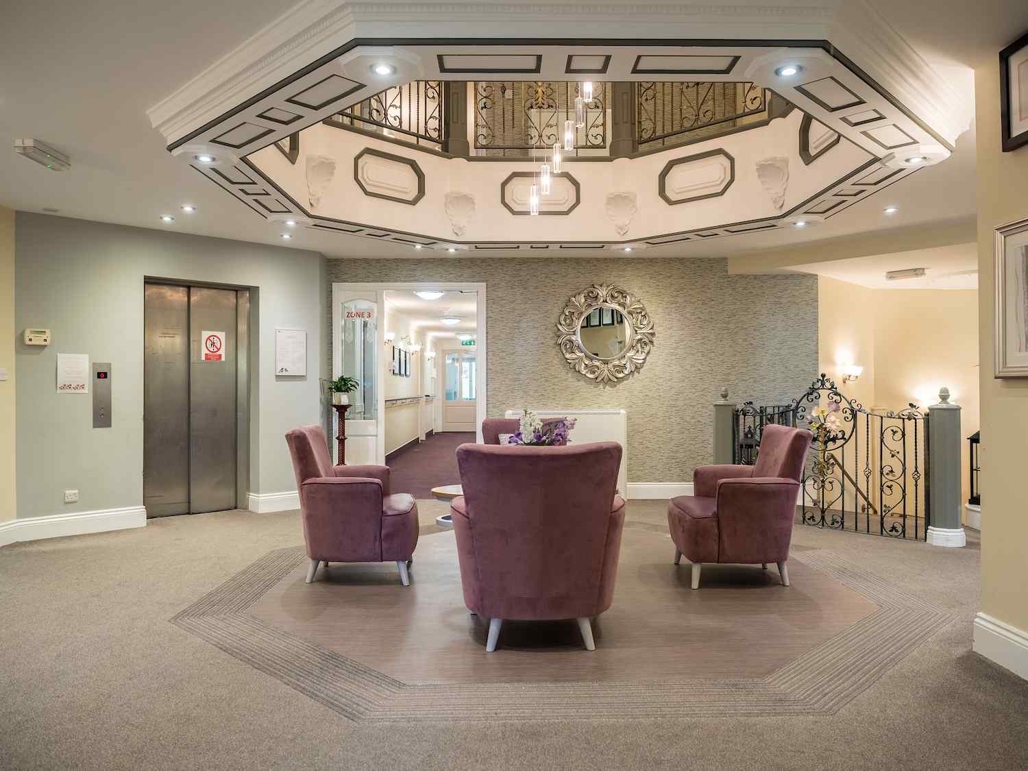our reception area with purple armchairs and a welcome desk